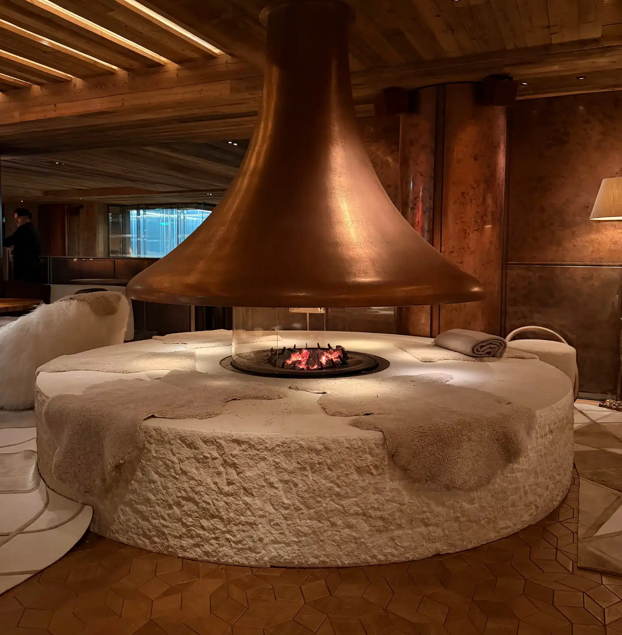Luxury restaurant in Courchevel with large round copper fireplace