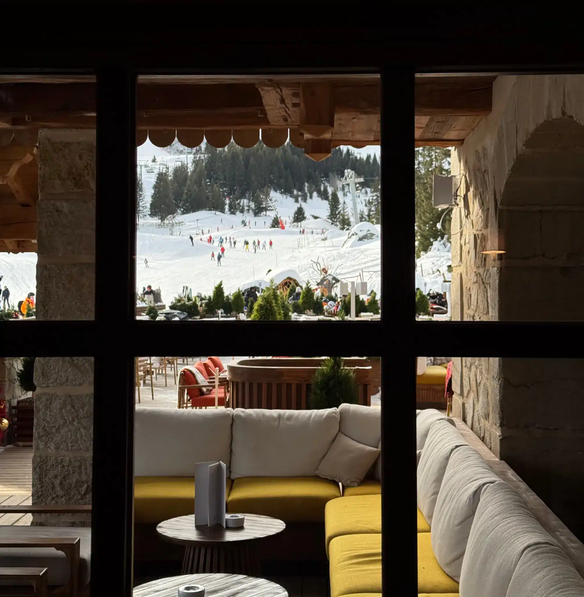 Interior of a restaurant in Courchevel with ski slope view
