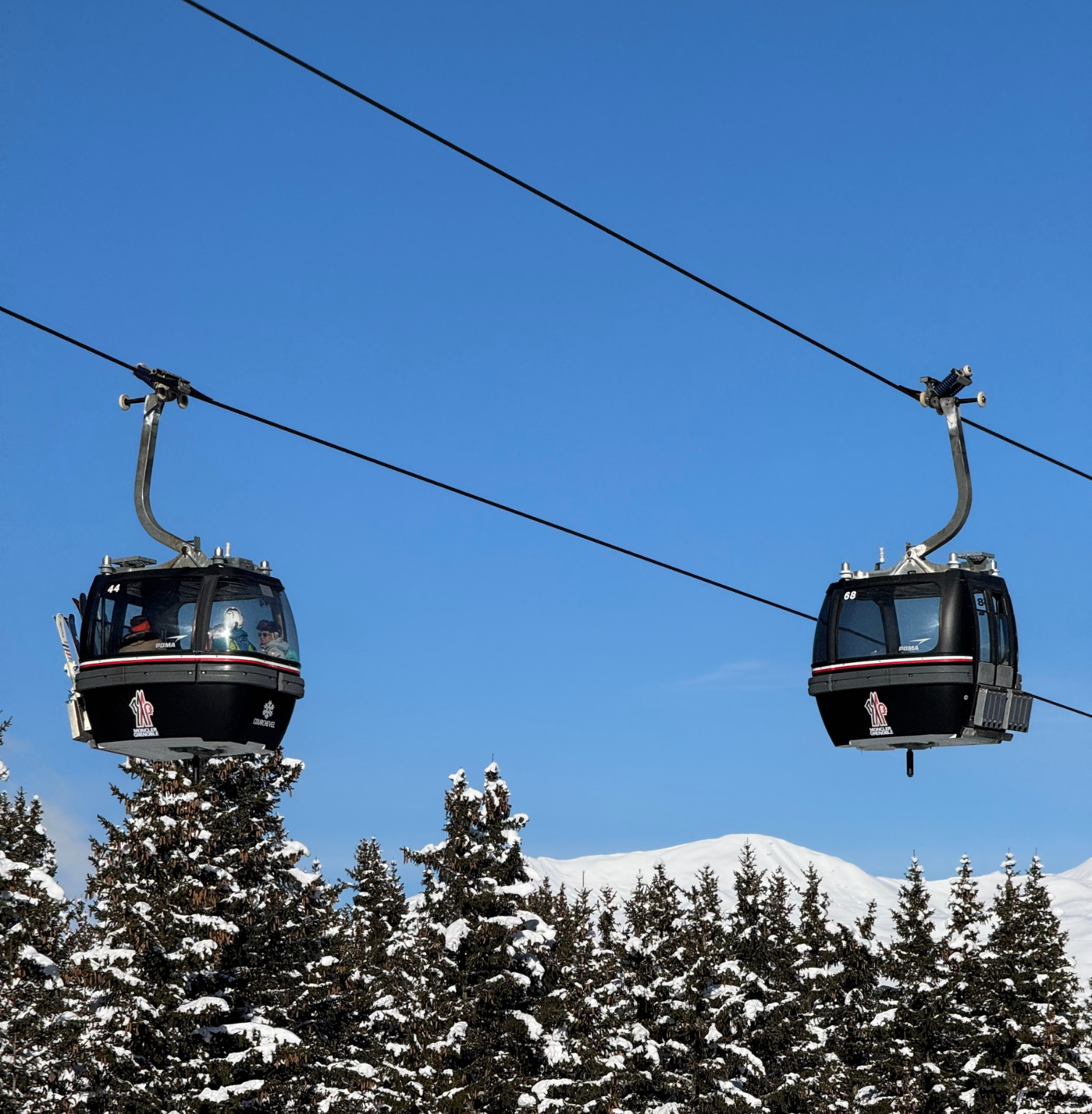 Ski lift in Courchevel 1850 with snowy mountains