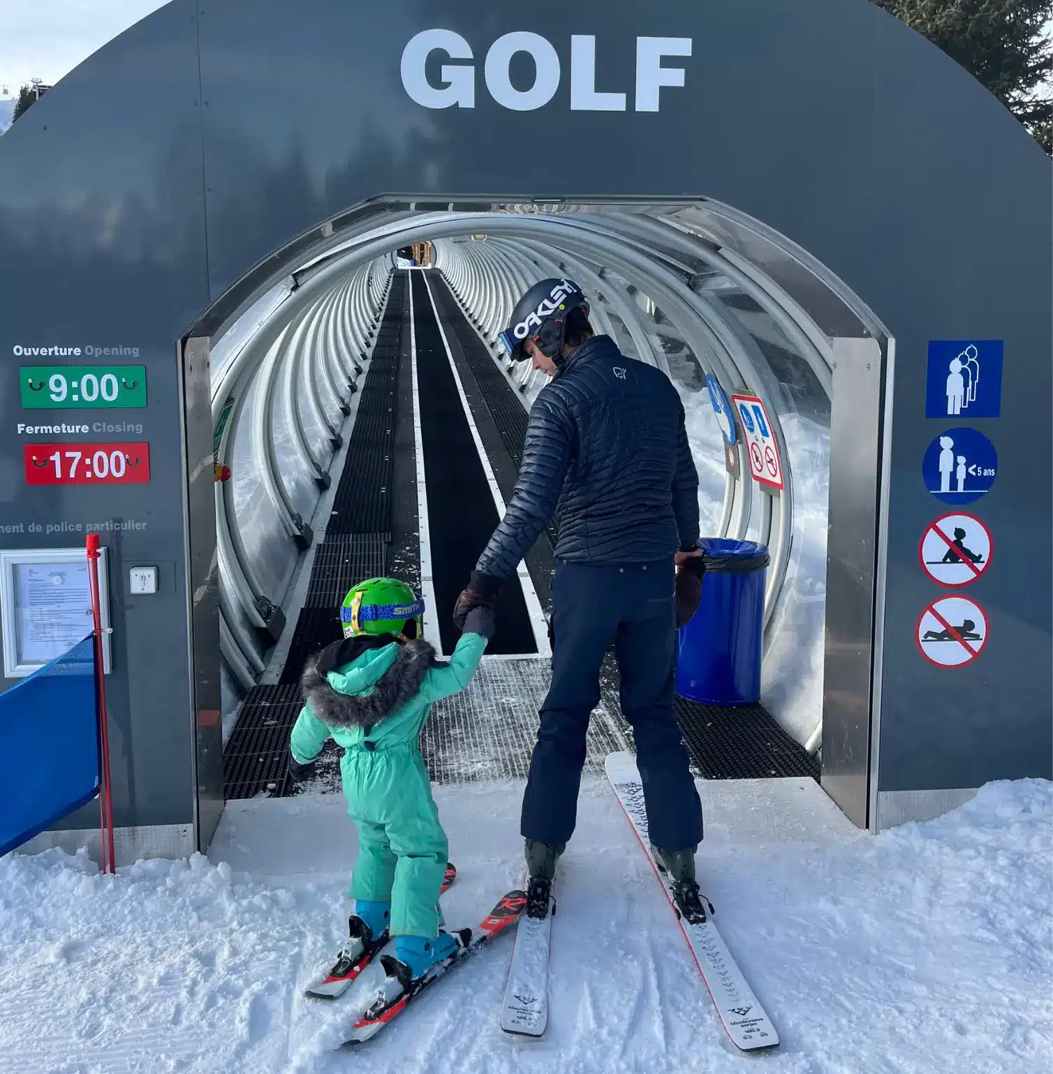 Ski instructor giving lesson to a child on snowy slopes