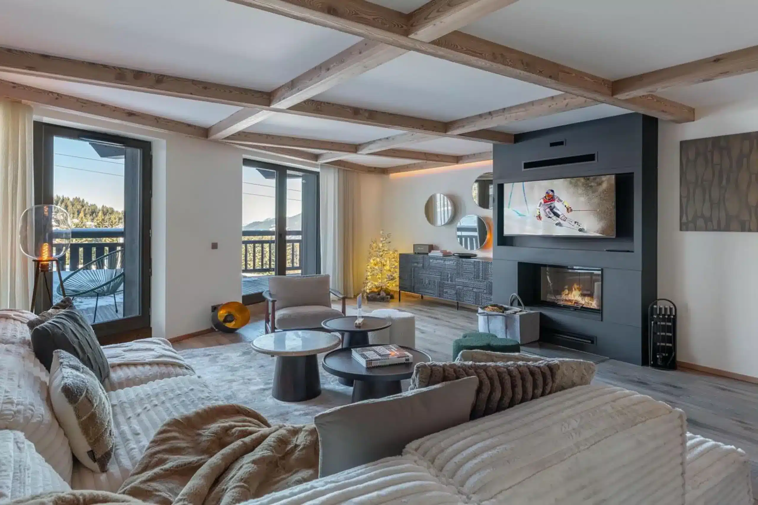 Cozy apartment bedroom with fireplace, TV and balcony view in Courchevel