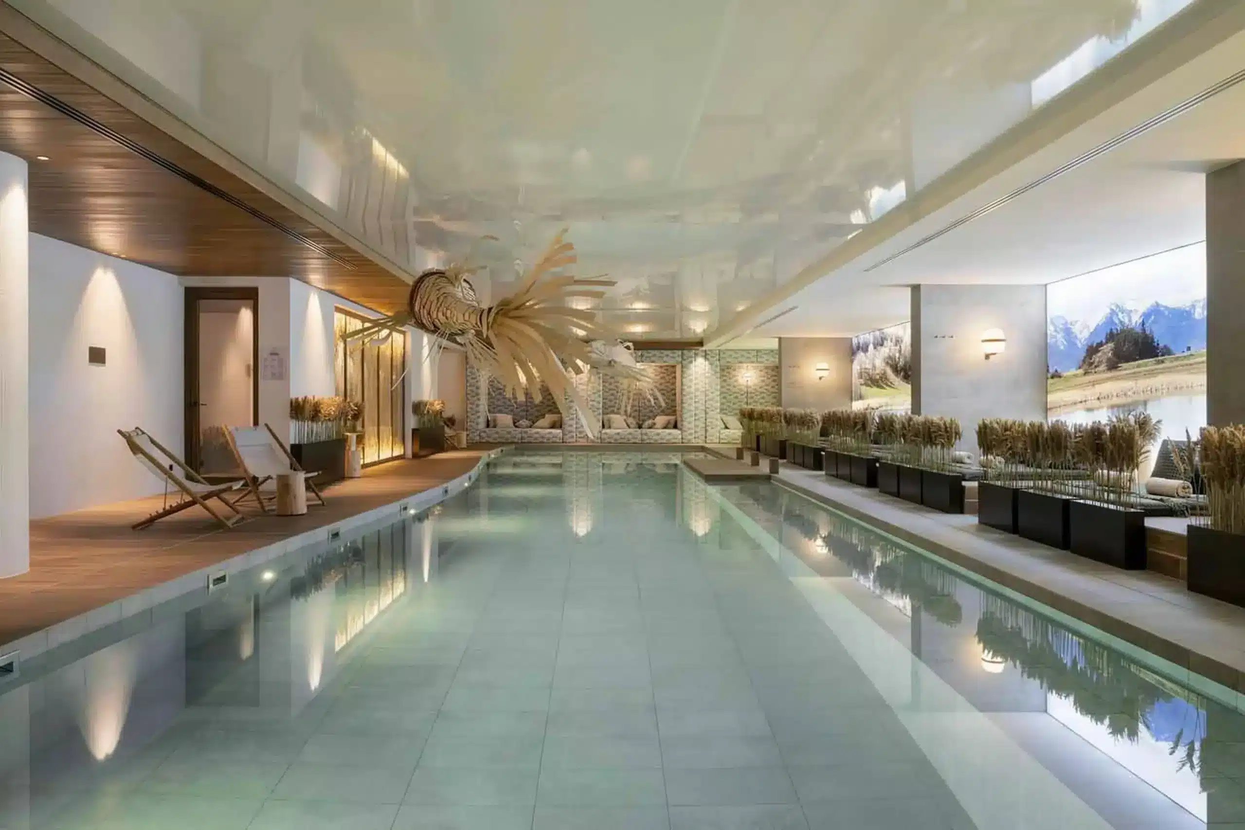 Indoor heated pool with mountain view mural in a luxury Courchevel apartment residence