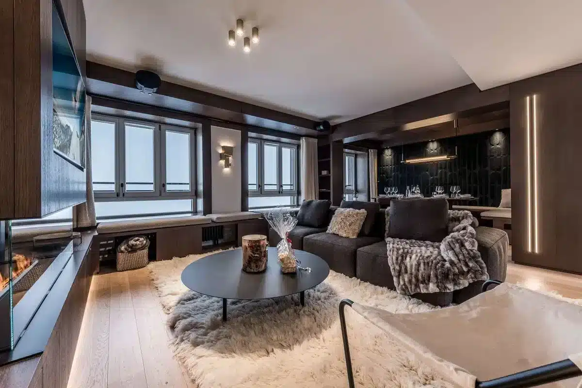 Modern apartment living room with fireplace and mountain view in Courchevel