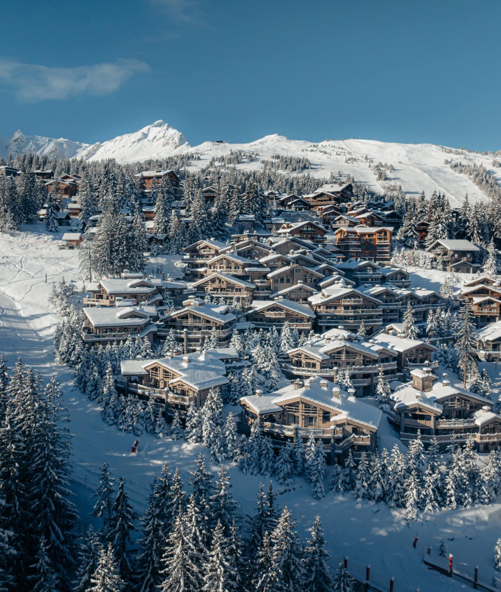 Aerial view of K2 Palace nestled among snow-covered chalets in Courchevel 1850