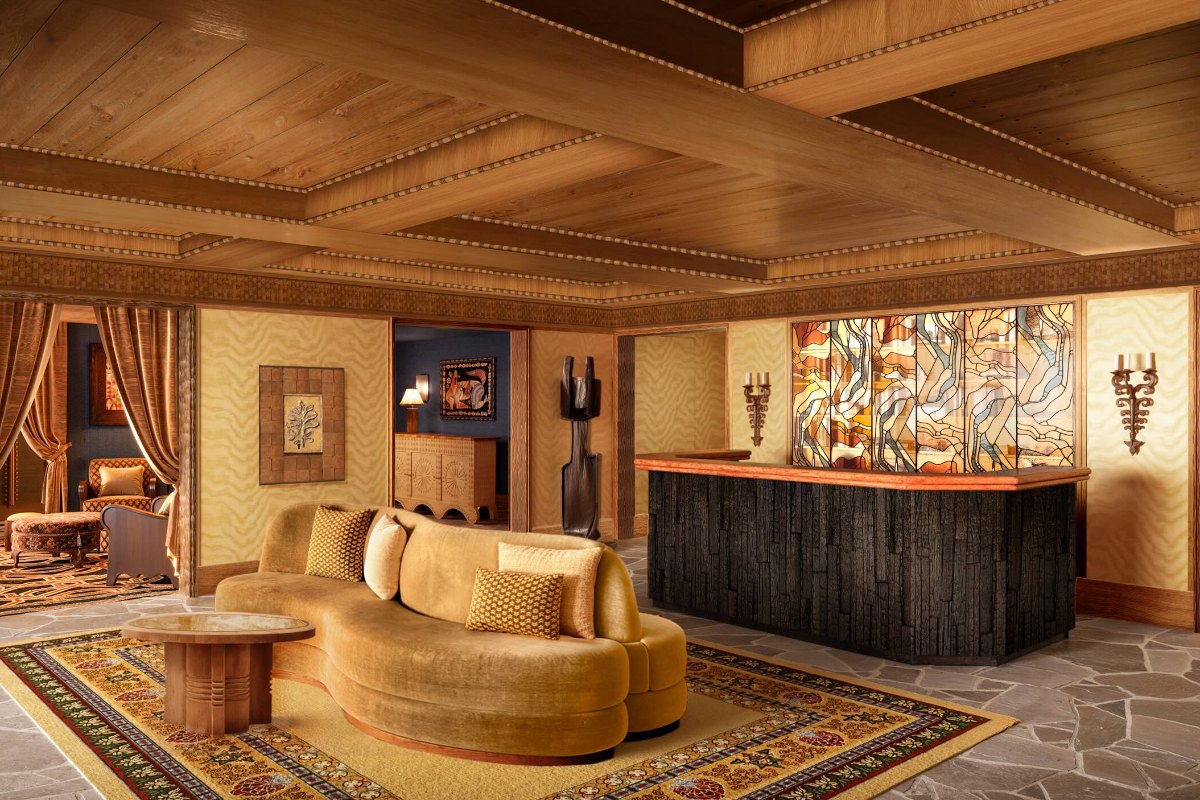 Hotel lobby with stained glass and a curved velvet sofa