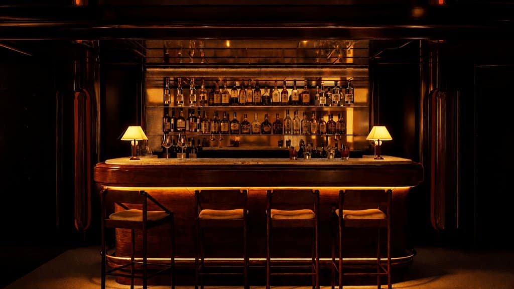 Lit bar with bottle display and stools at Simonetta, Bourbon Hotel, Courchevel 1850