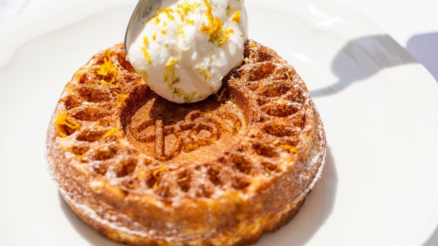 Waffle dessert with whipped cream and citrus zest at ZIA, La Sivolière, Courchevel 1850